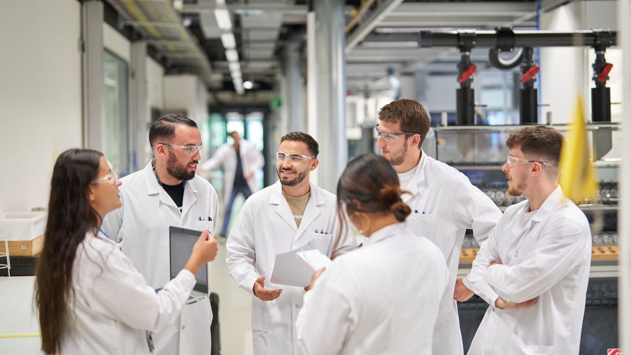 Group of scientists in the lab talking and laughing