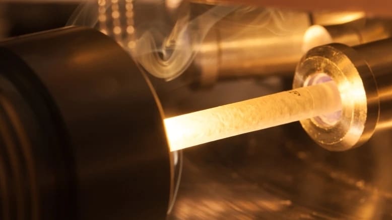 Close-up of a smoking machine with cigarette