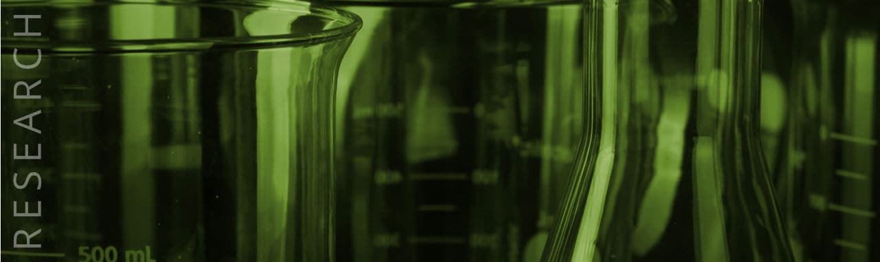 Green glass flasks on research page banner