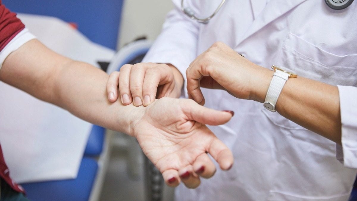 Medical worker measures a patient's blood pressure.