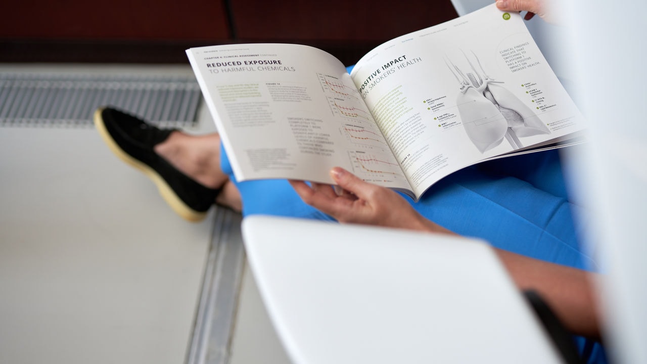 Women reading PMI Science booklet